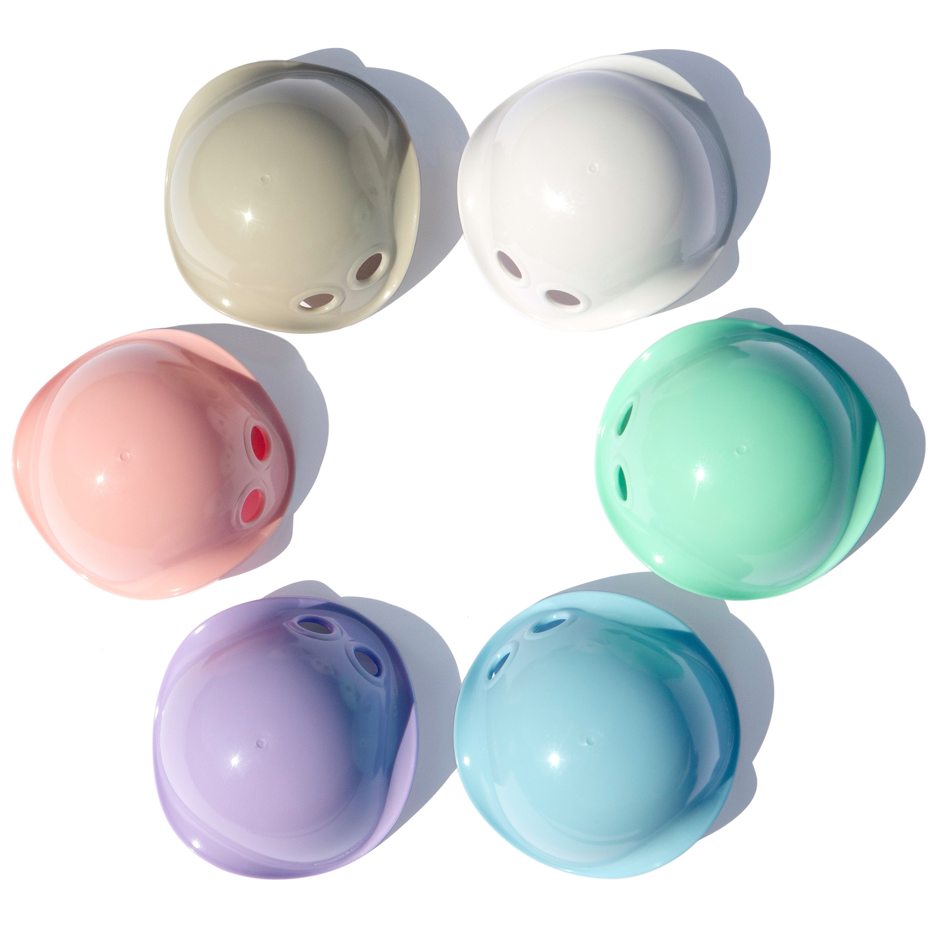 Six Bilibo Mini nesting and sorting cups by MOLUK in soft pastel colors.