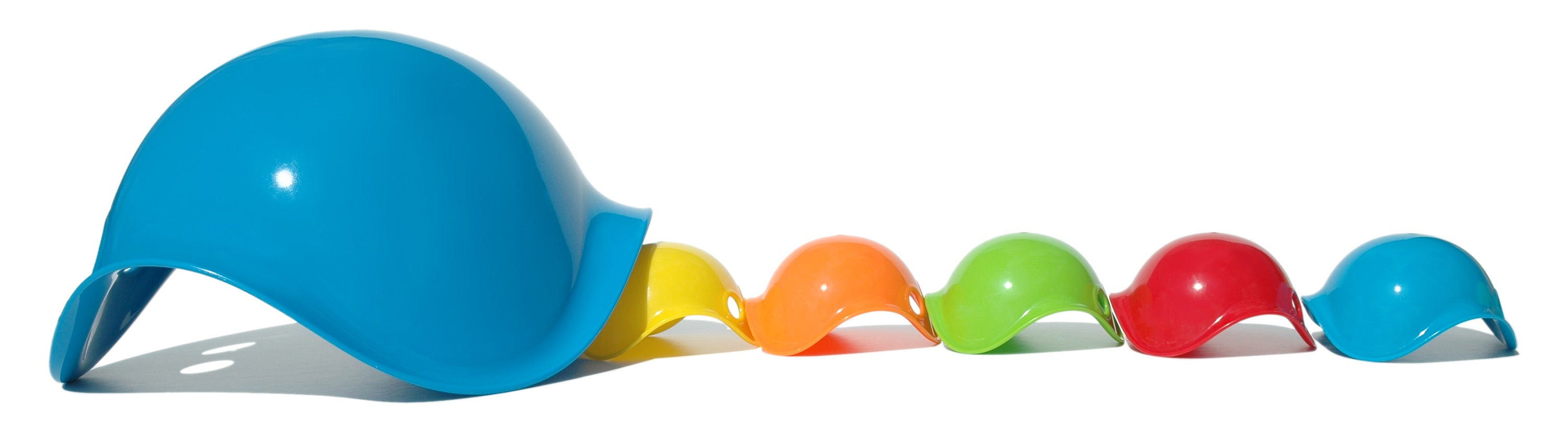 A row of colorful Bilibo Mini shells by MOLUK emerging from a large blue Bilibo shell like little ducklings.