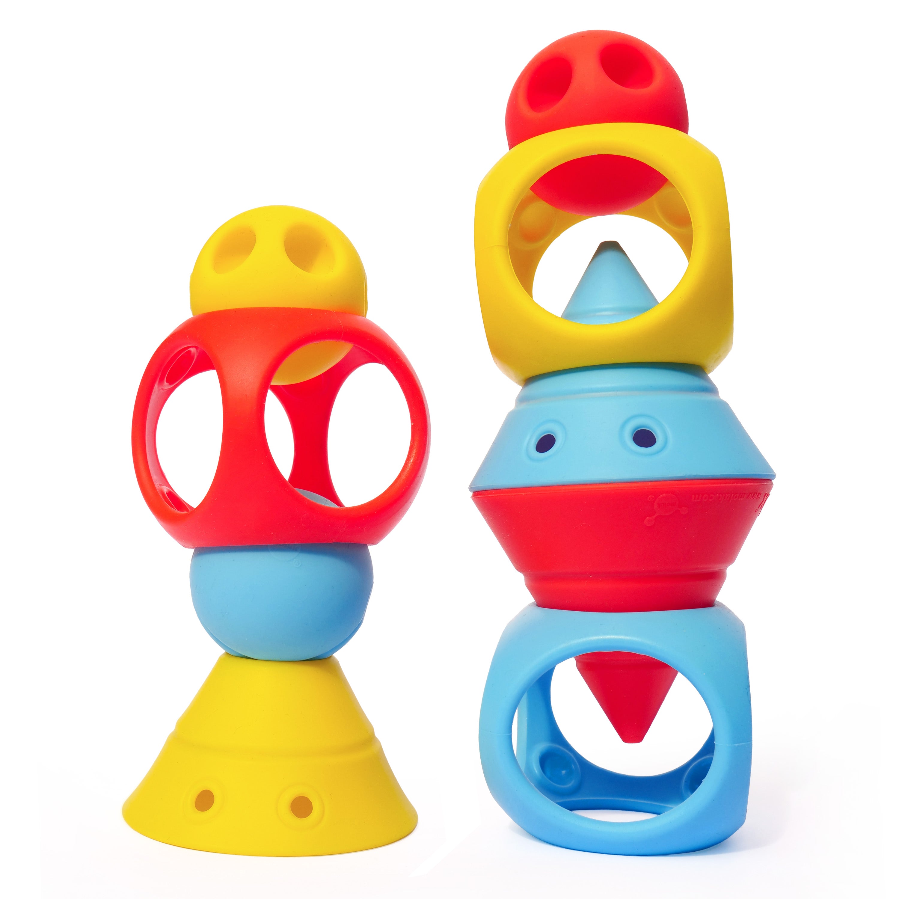 Colorful BUILDING GENIUS creations by MOLUK, with Hix cones, Mox balls, and Oibo cubes in red, yellow, and blue stacked into playful tower figures.