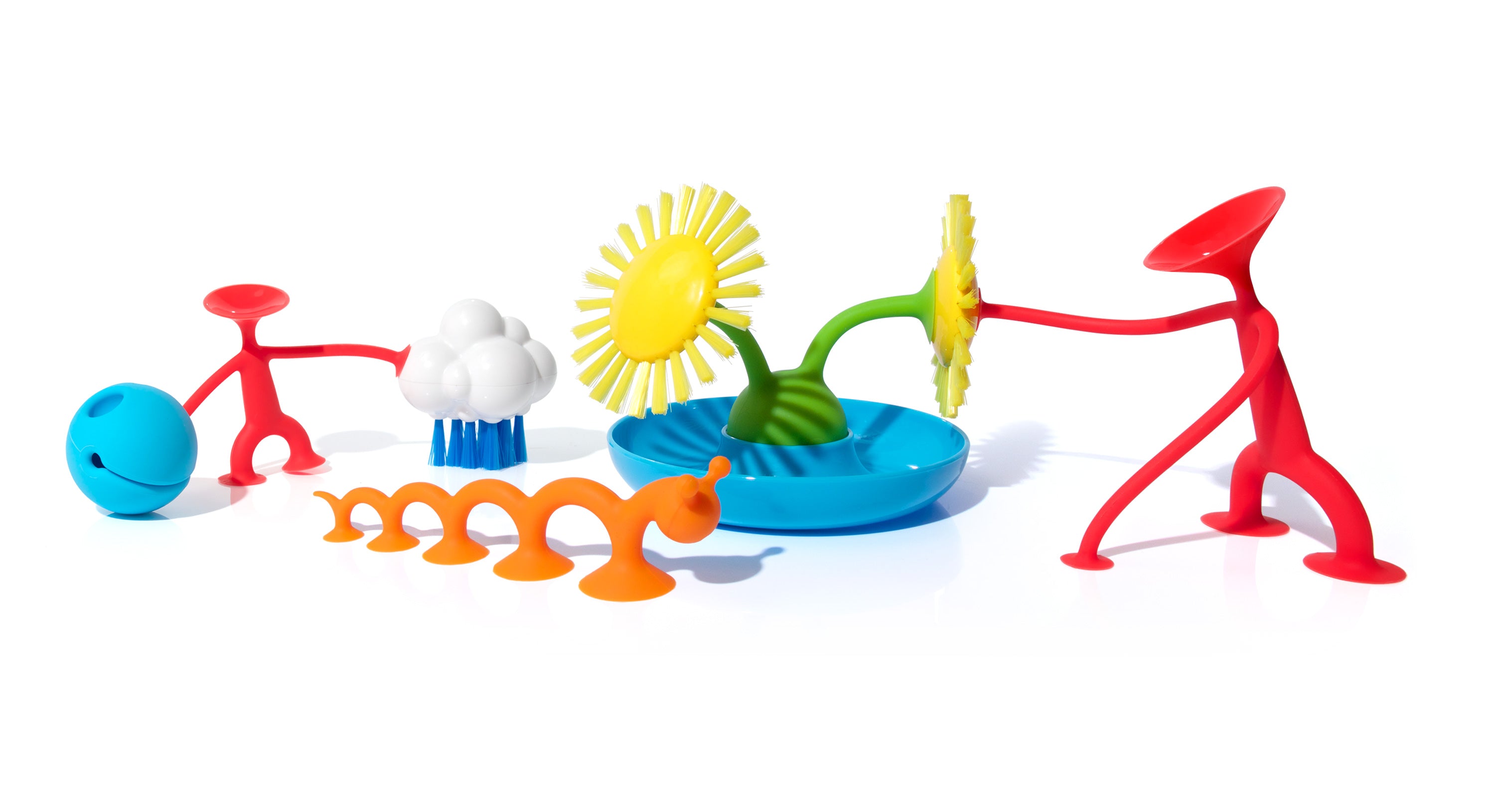 Line-up of MOLUK open-ended toys including Oogi, Mox, Pluï Cloud, Pluï Brush Sunny, Oogi Bongo and Oogi Pilla, arranged together in a playful scene.