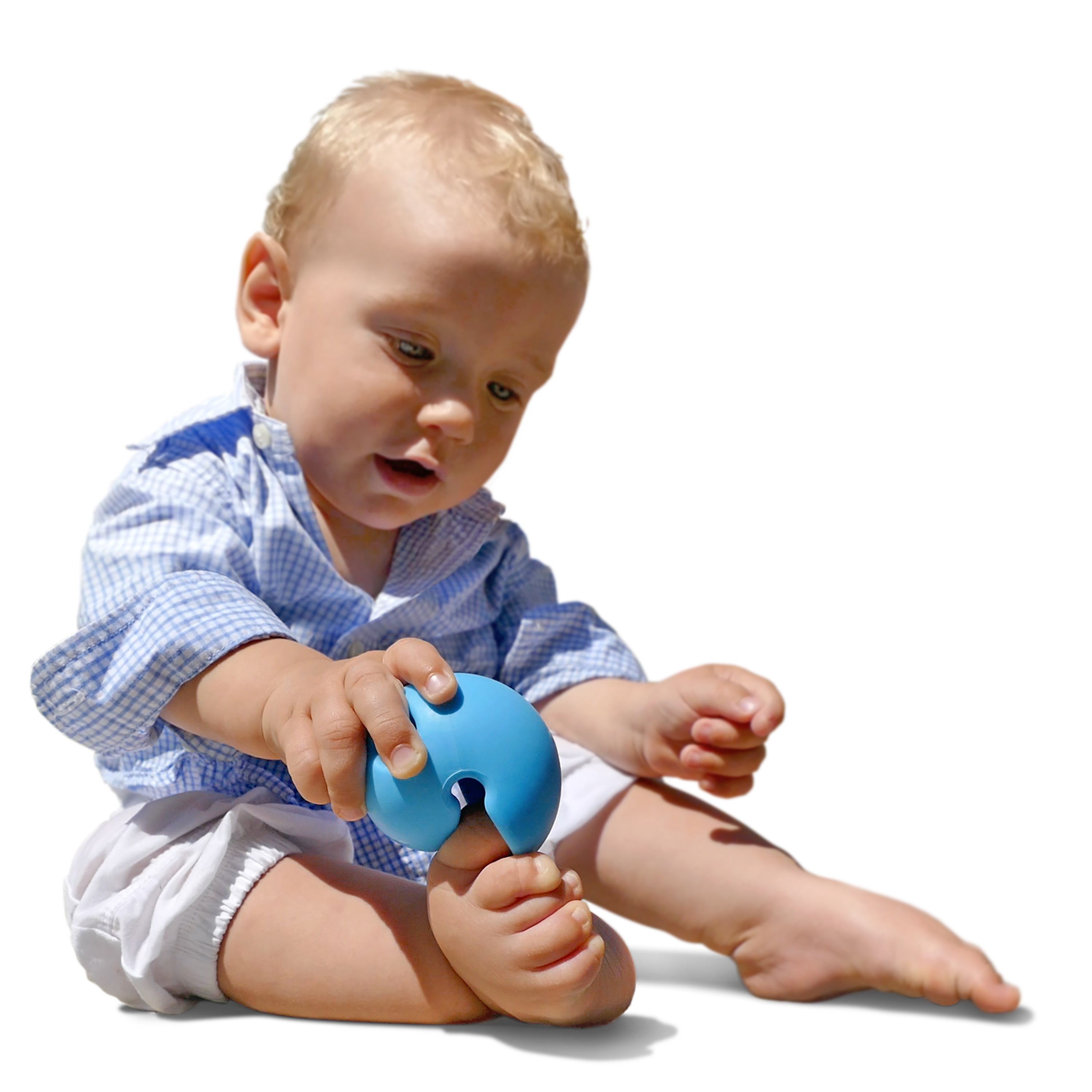 Baby playing with a blue Mox silicone ball by MOLUK, squeezing it onto his toes during sensory exploration.