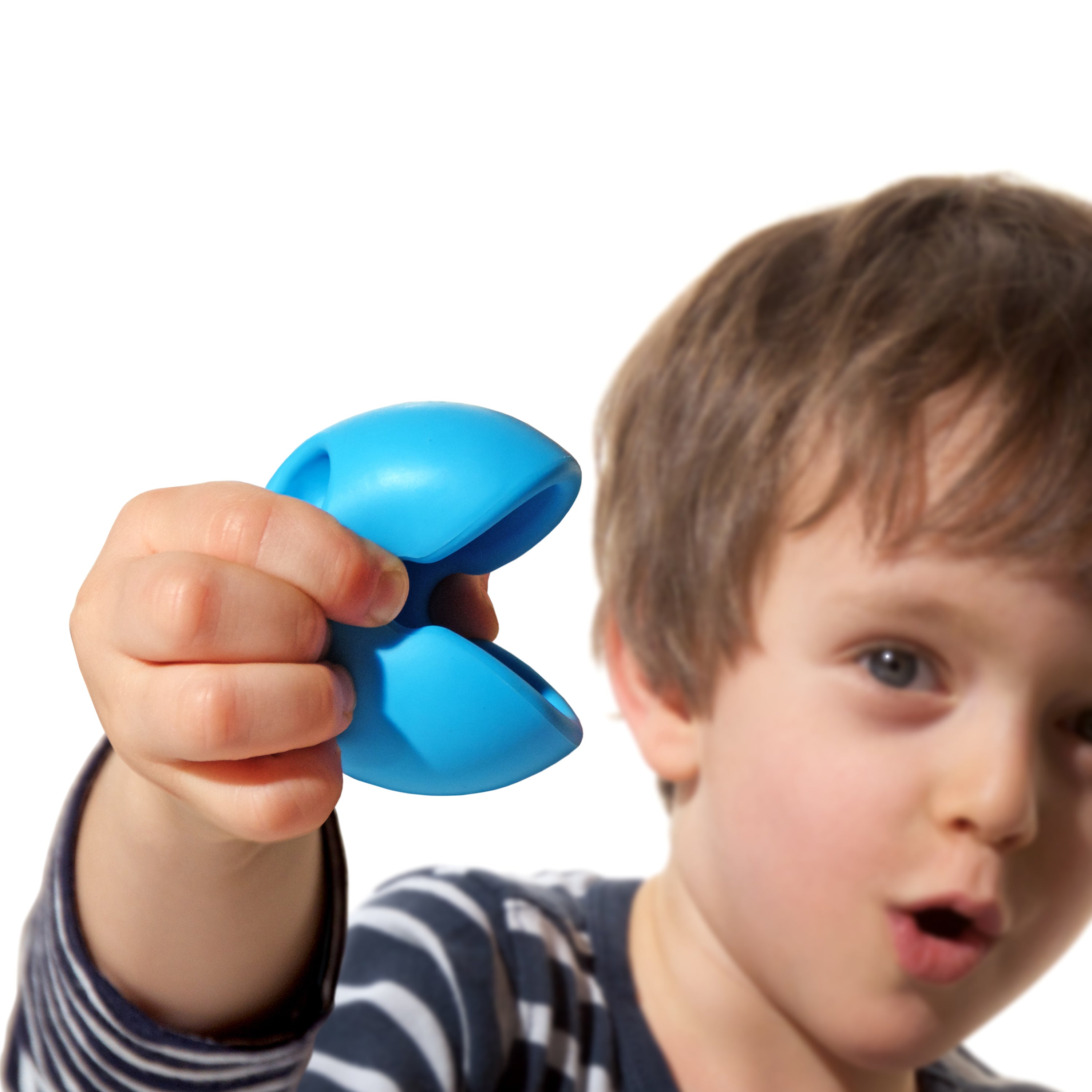 Boy holding and squeezing a blue Mox silicone fidget ball by MOLUK, opening its mouth in playful surprise.