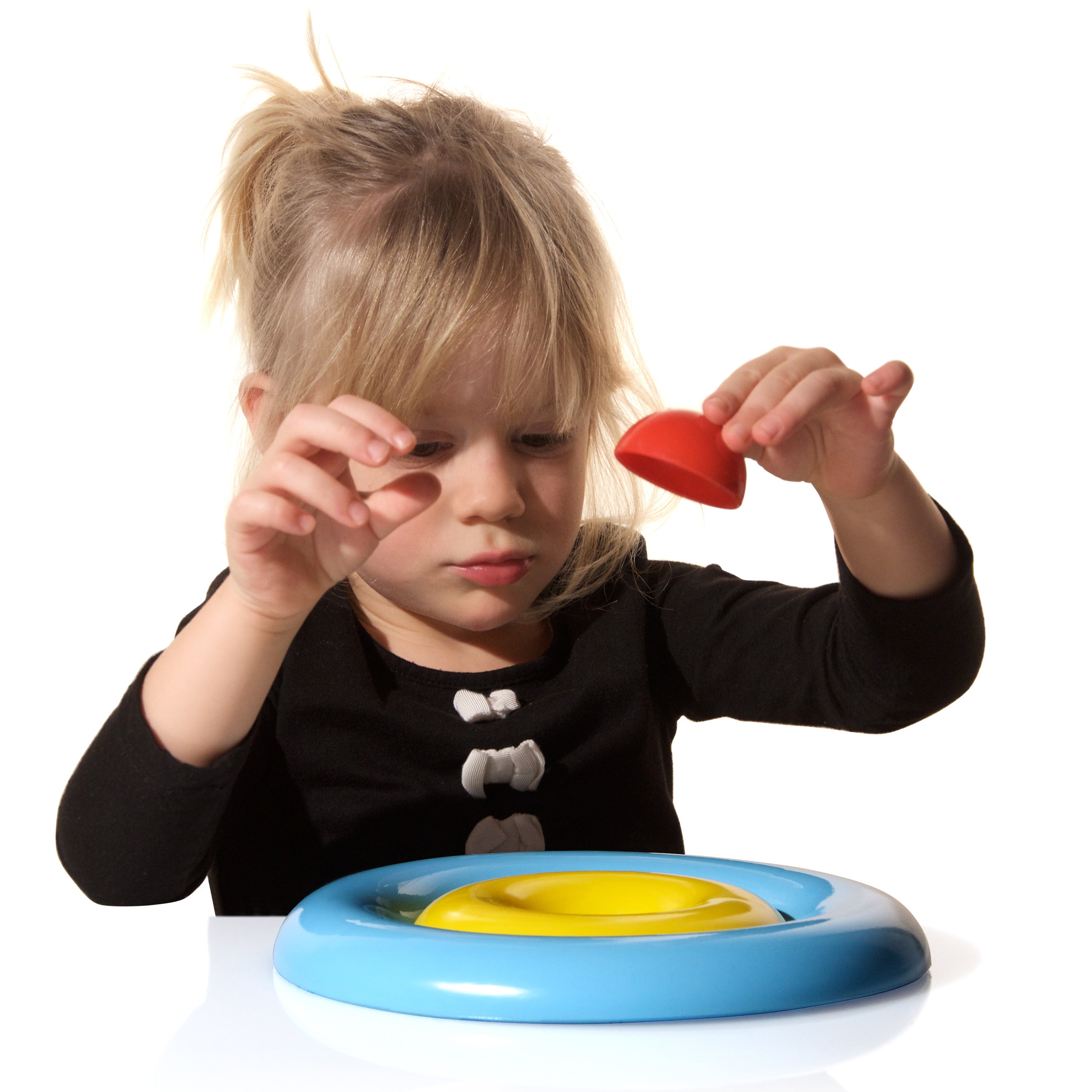 Child playing with colorful ring-shaped Nello nesting toy by MOLUK