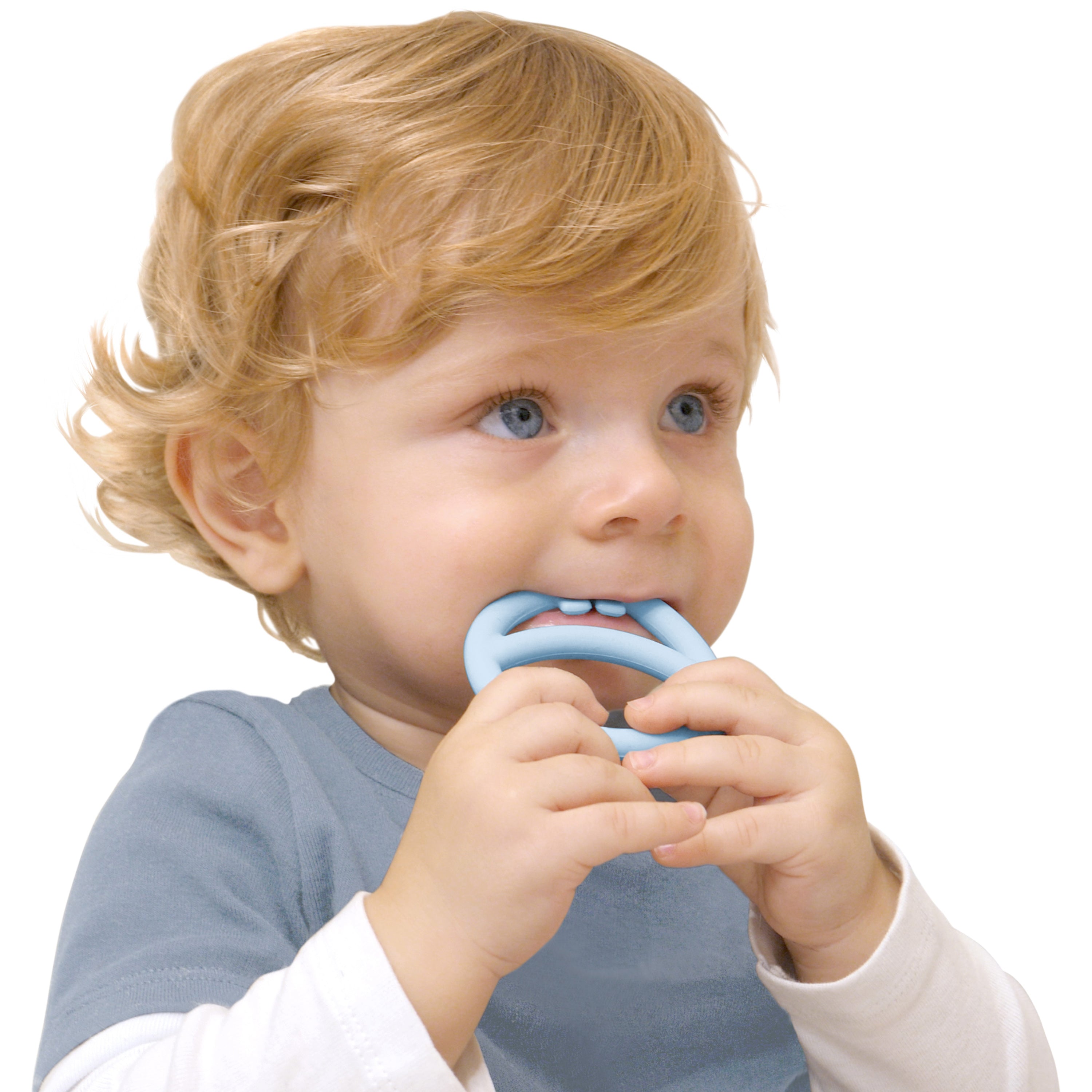 Child chewing on ice blue Nigi Nagi Nogi silicone teething ring by MOLUK, designed for tactile stimulation and soothing sore gums.