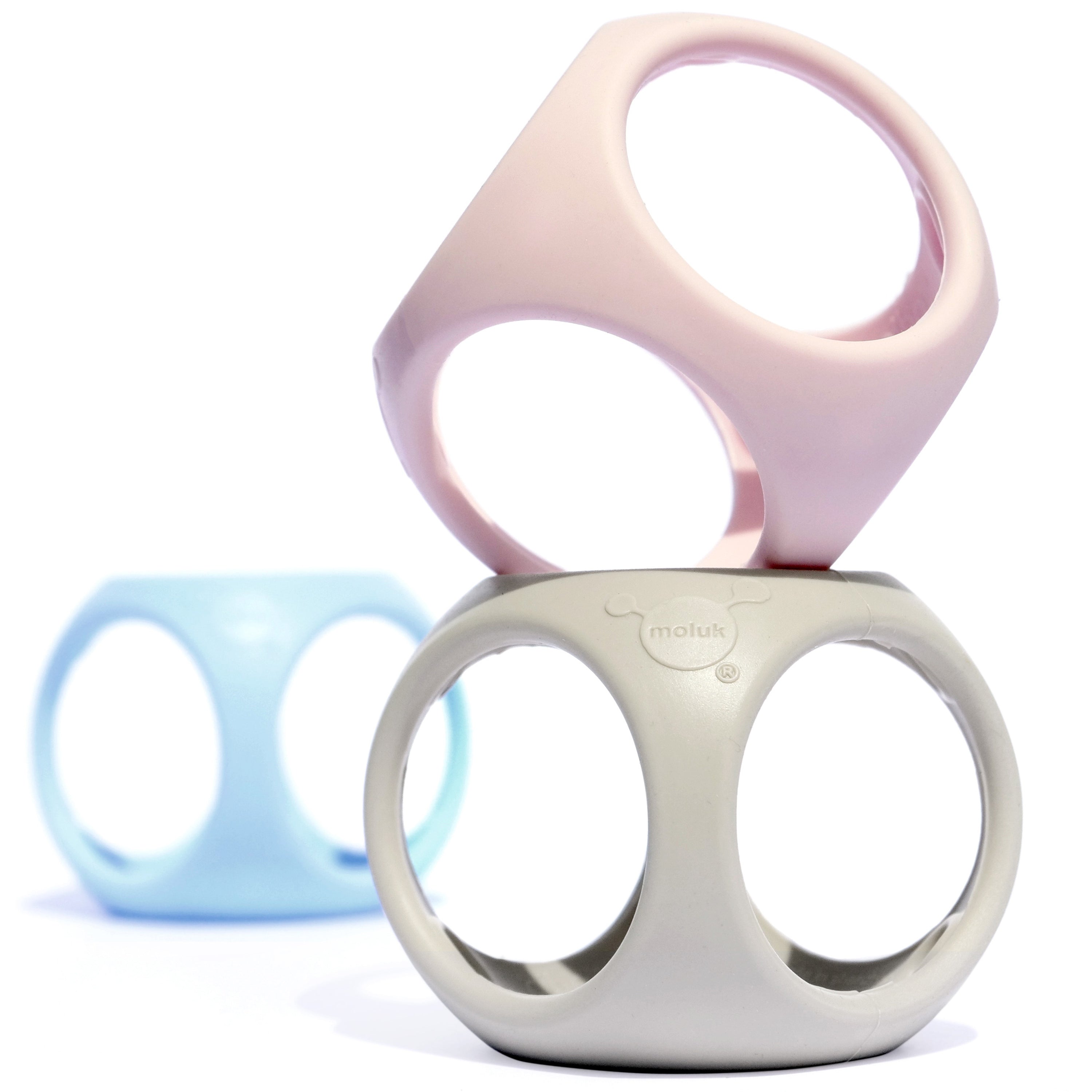 Stacked Oibo silicone cubes by MOLUK in soft pastel colors, combining the qualities of a ball and building block for open-ended play.
