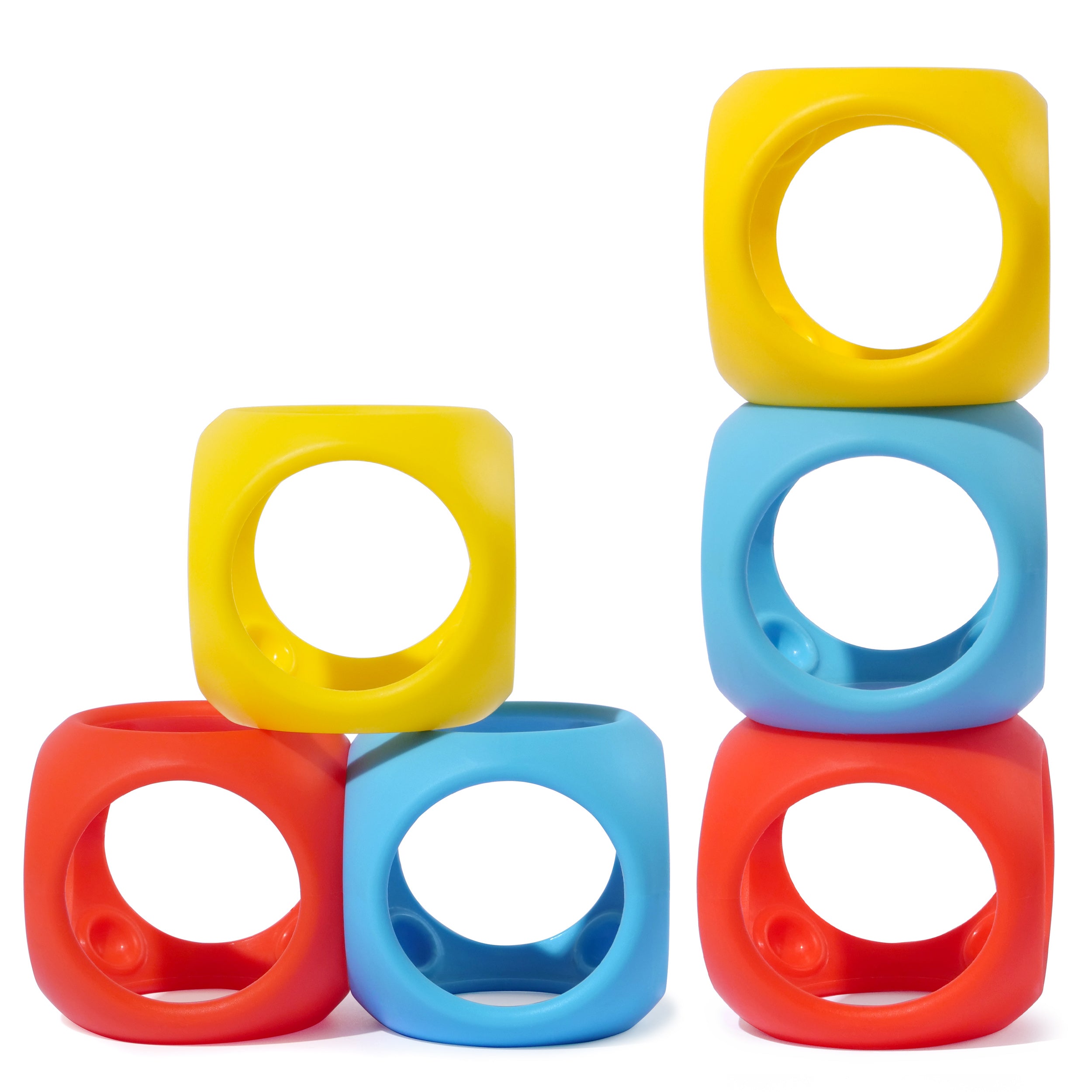 Colorful Oibo silicone cubes by MOLUK in red, yellow, and blue, stacked into playful towers for open-ended building and sensory play.