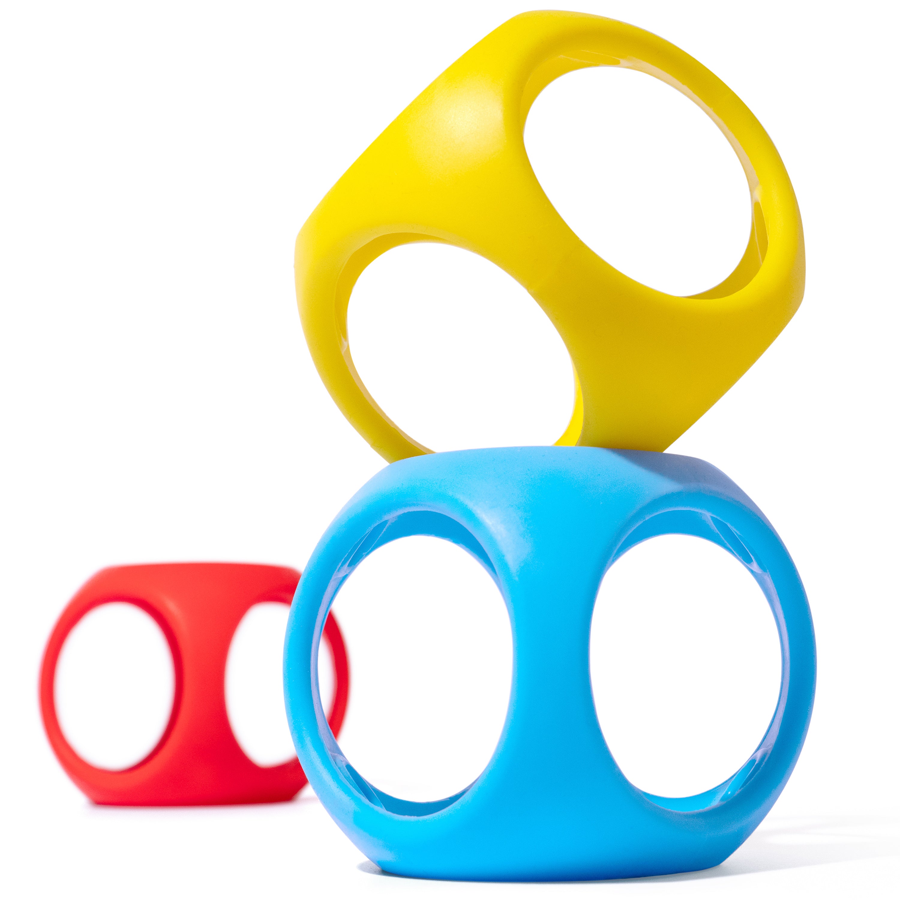 Stacked Oibo silicone cubes by MOLUK in blue, yellow, and red, combining the qualities of a ball and building block for open-ended play.