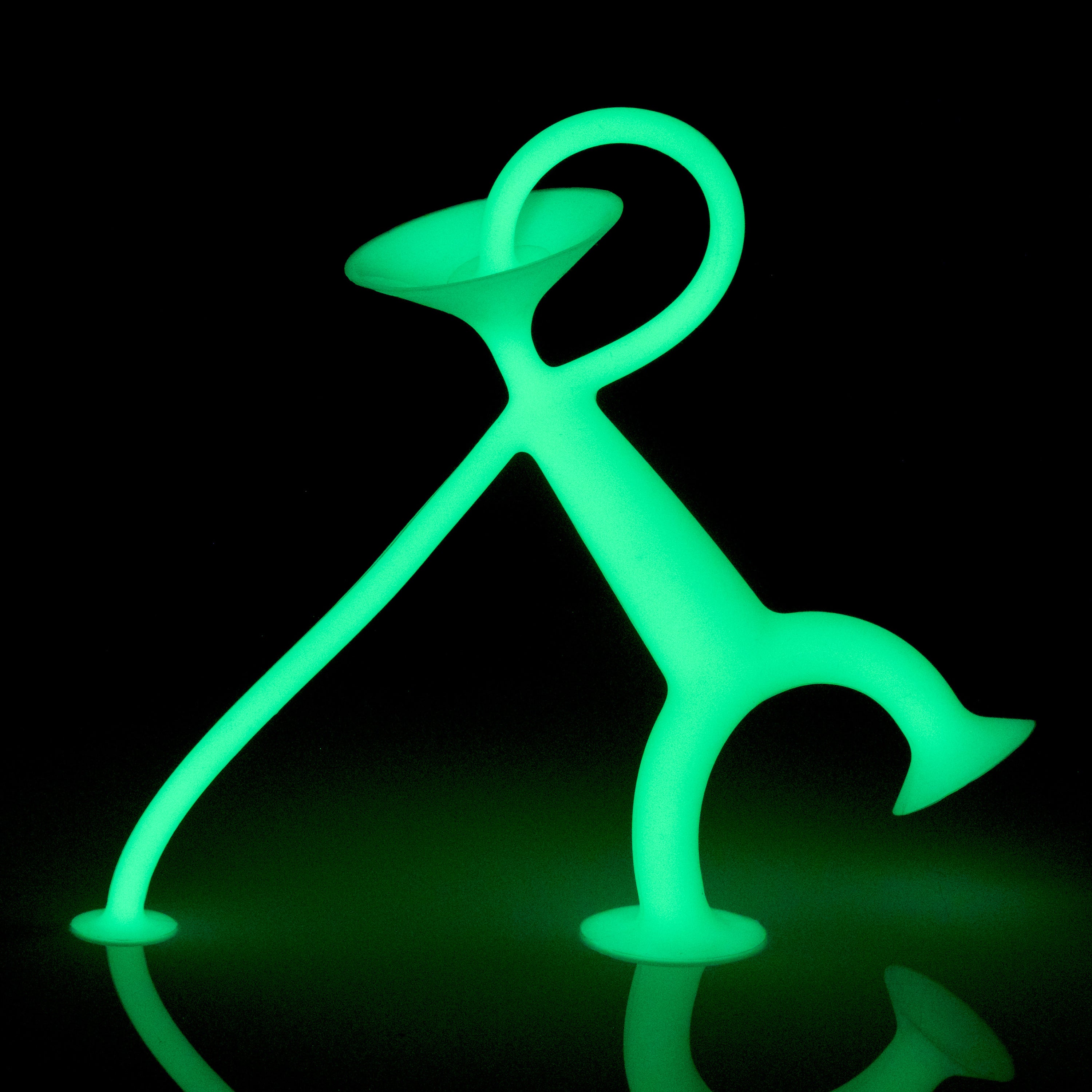 Oogi GLOW by MOLUK, a green silicone suction cup figure that glows in the dark, with suction head, hands, and feet for playful, expressive sticking and stretching.