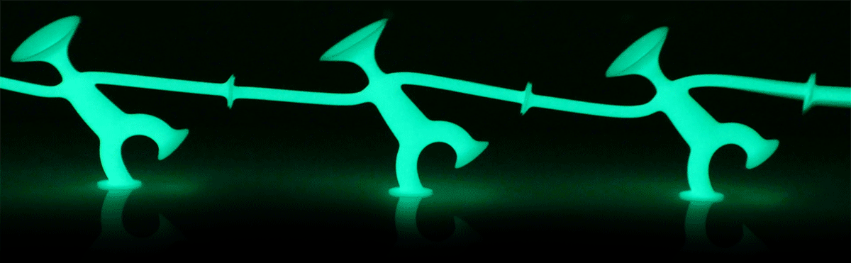 Three Oogi Junior GLOW figures by MOLUK dancing in the dark.