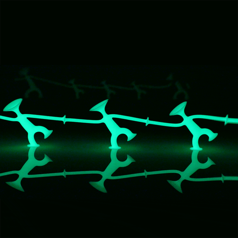 Three Oogi Junior GLOW fidget figures by MOLUK, shown dancing at night.