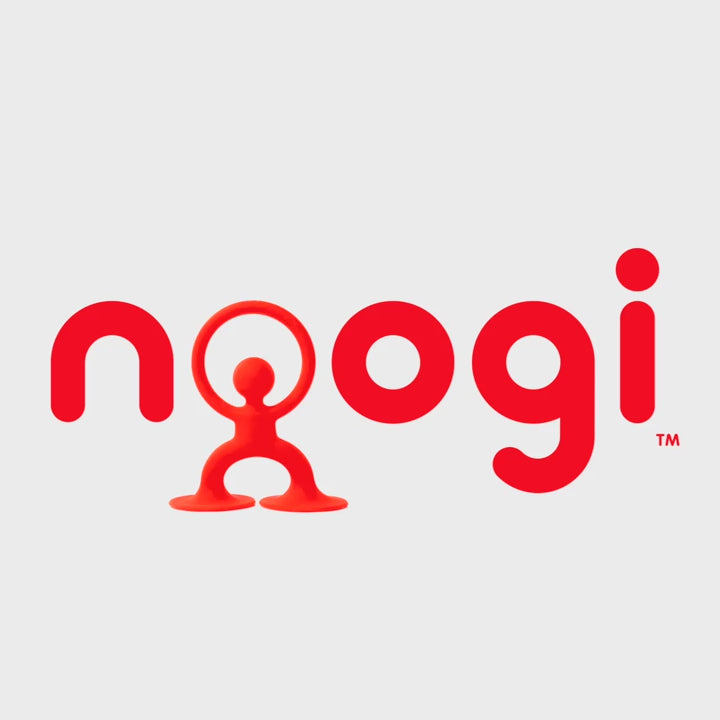 Video of baby playing with red Noogi silicone toy by MOLUK, grasping and pulling the friendly figure for teething and sensory play.
