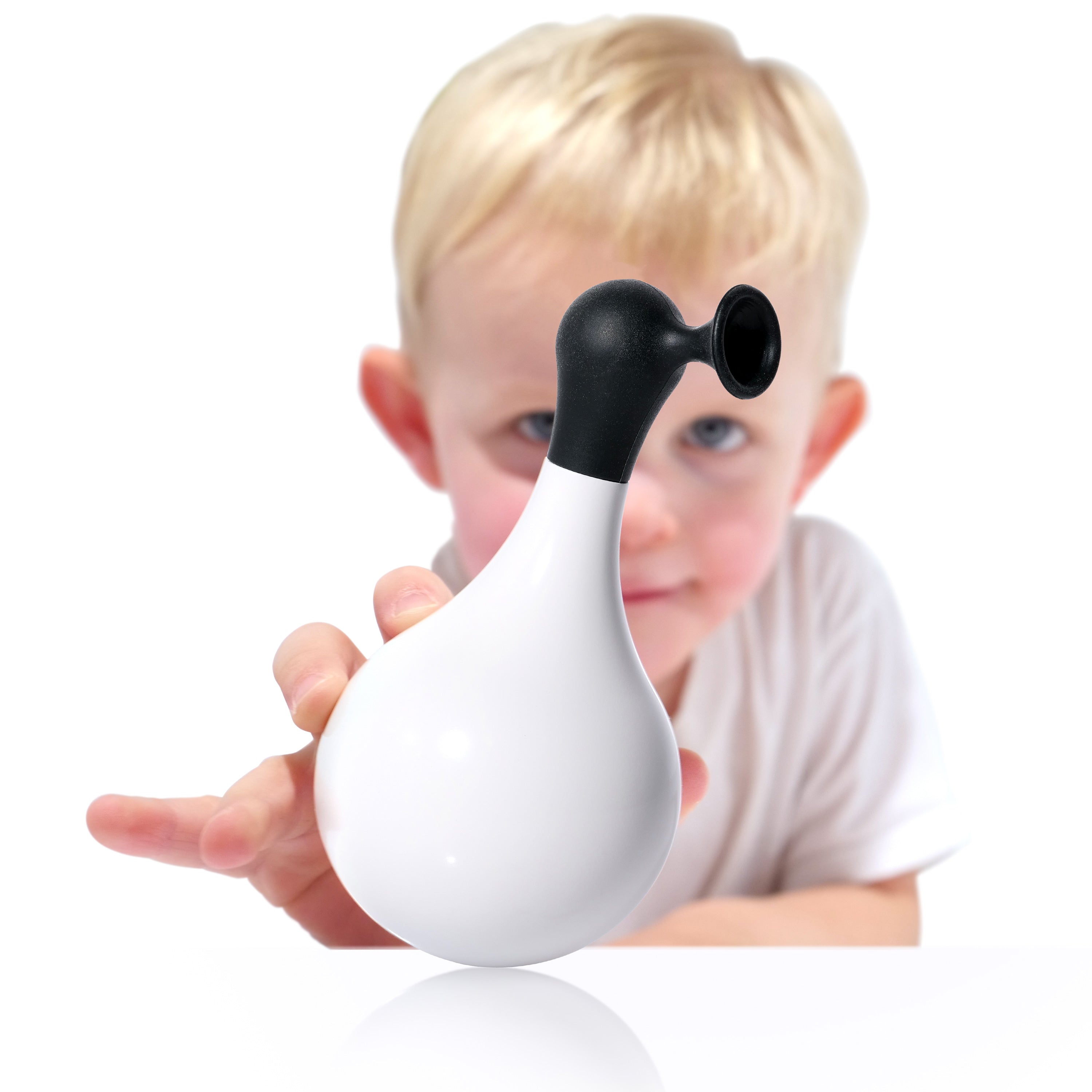 Boy holding a black and white self-righting Boi wobble and bath toy by MOLUK.