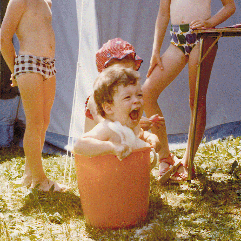 Slide show with images of Alex and Doris Hochstrasser from their childhood in the Swiss countryside, playing indoors and outdoors.