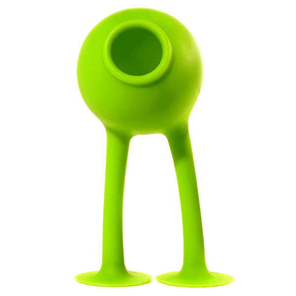 Green Oogi Bongo suction cup silicone toy by MOLUK, reminiscent of a friendly alien monster, swaying sideways.