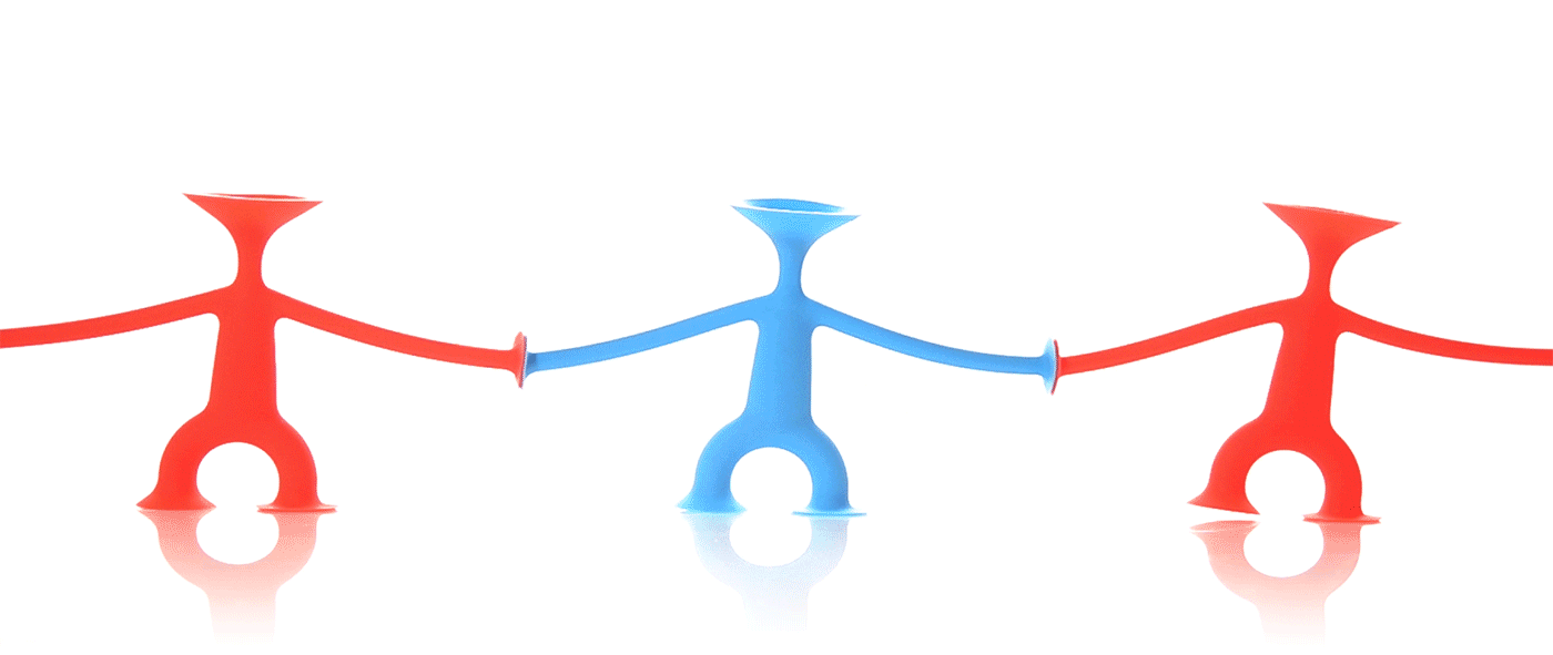Blue and red Oogi Junior suction cup fidget figures by MOLUK holding hands and dancing.