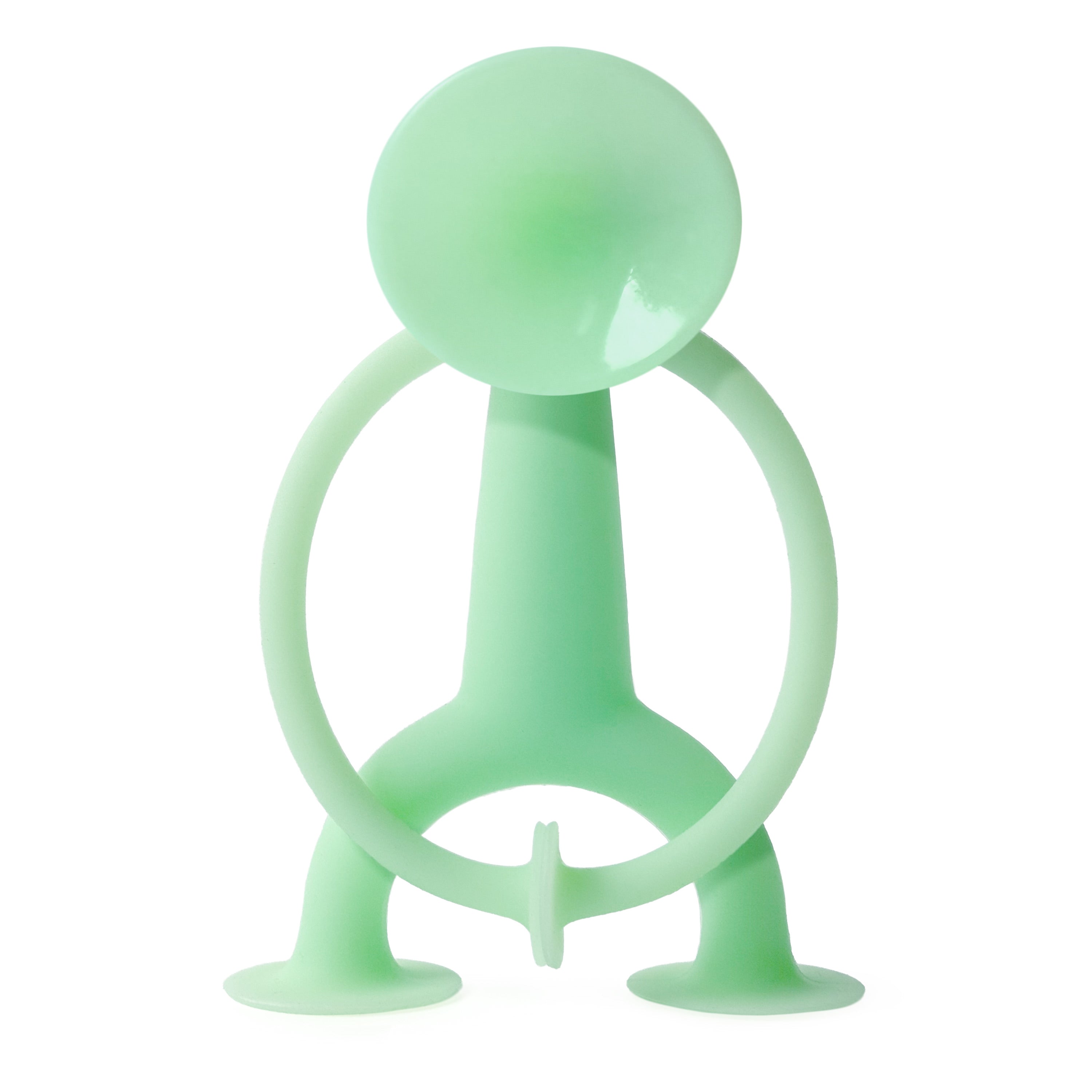 Oogi GLOW by MOLUK, a light green silicone suction cup figure that glows in the dark, shown in daylight.