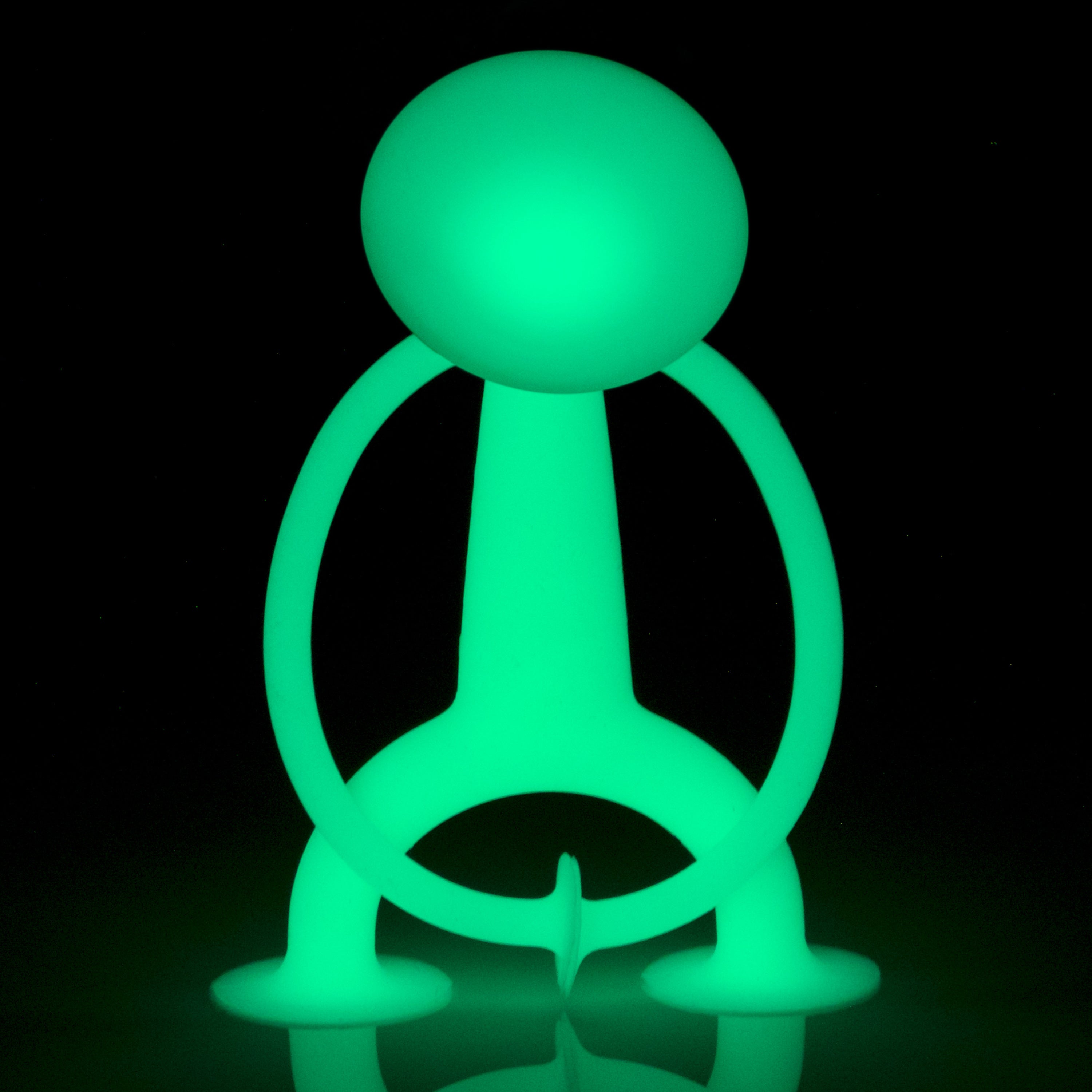 Oogi GLOW by MOLUK, a silicone suction cup figure that glows in the dark, for sensory and imaginative play.