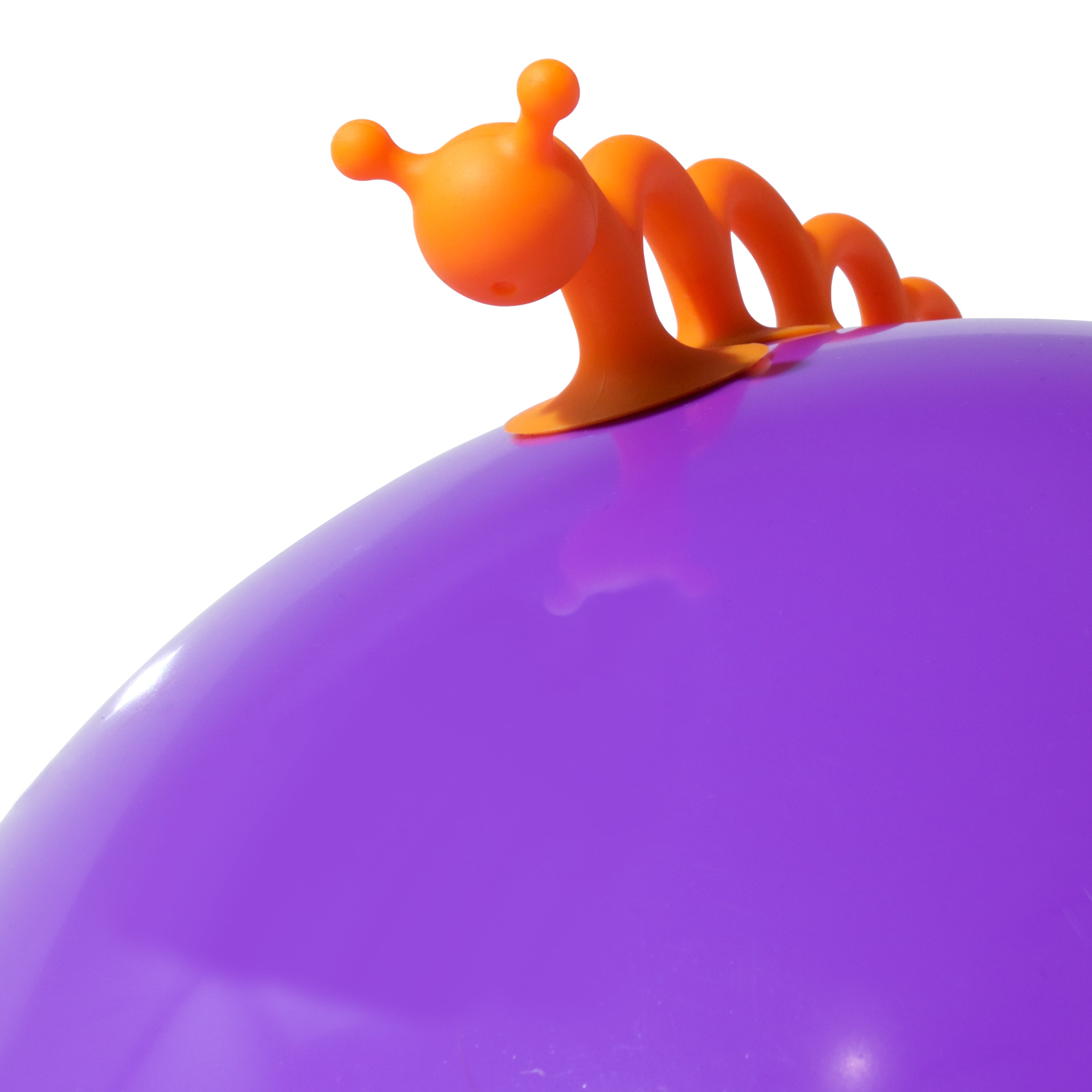 Orange Oogi Pilla silicone suction cup toy by MOLUK on a purple Bilibo shell.