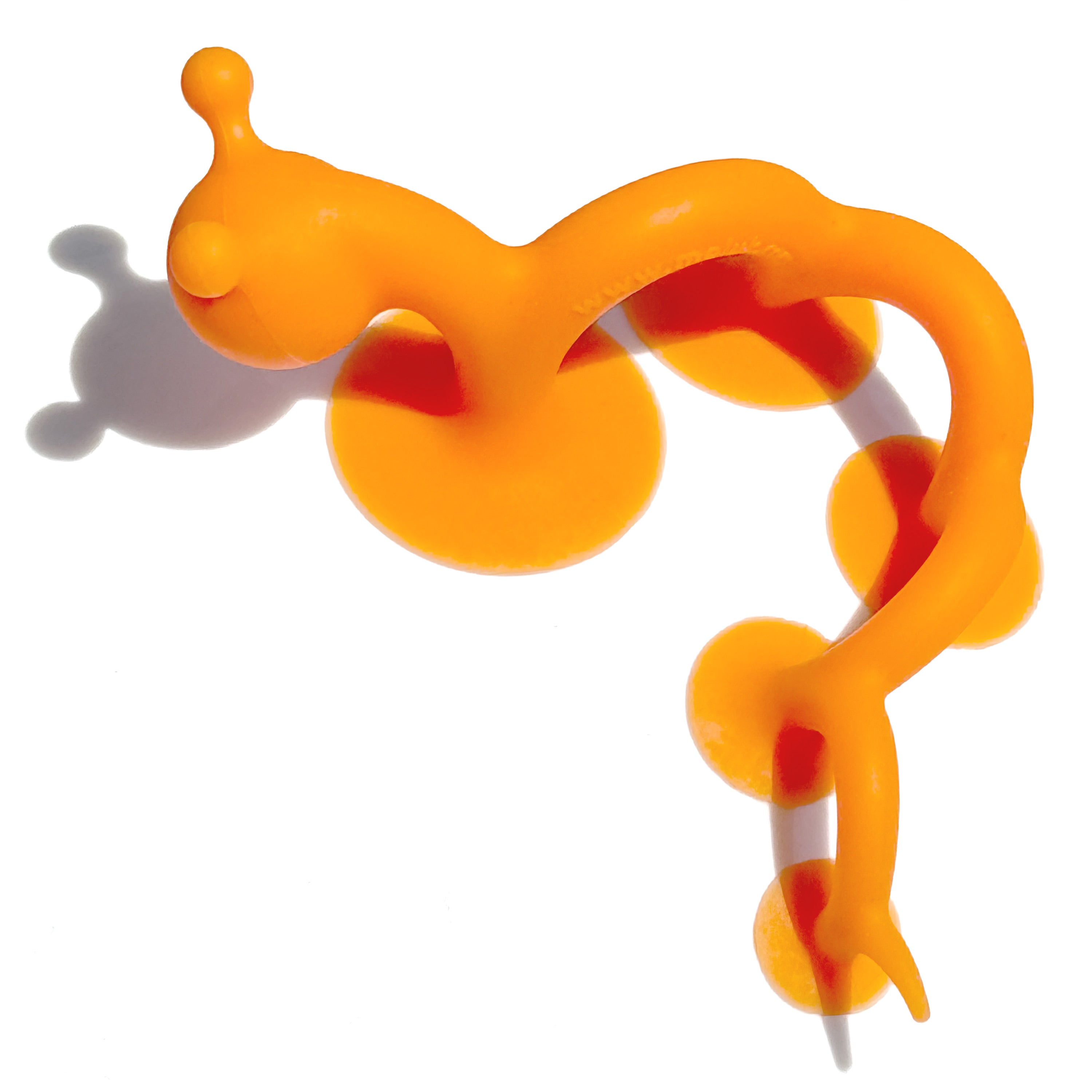 Orange Oogi Pilla sensory fidget toy with a flexible silicone body and multiple suction pads.