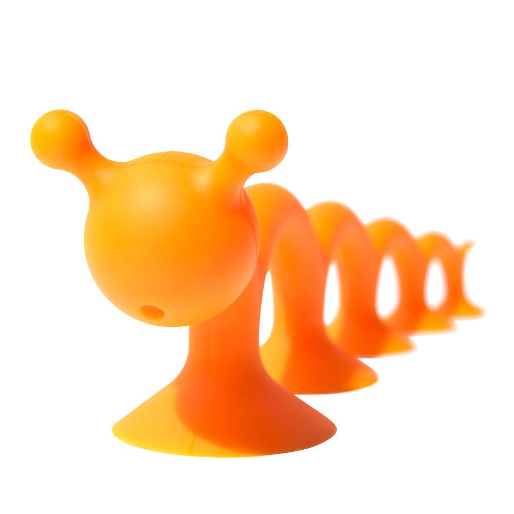 Orange Oogi Pilla by MOLUK, a silicone suction cup creature as fidget and sensory toy.