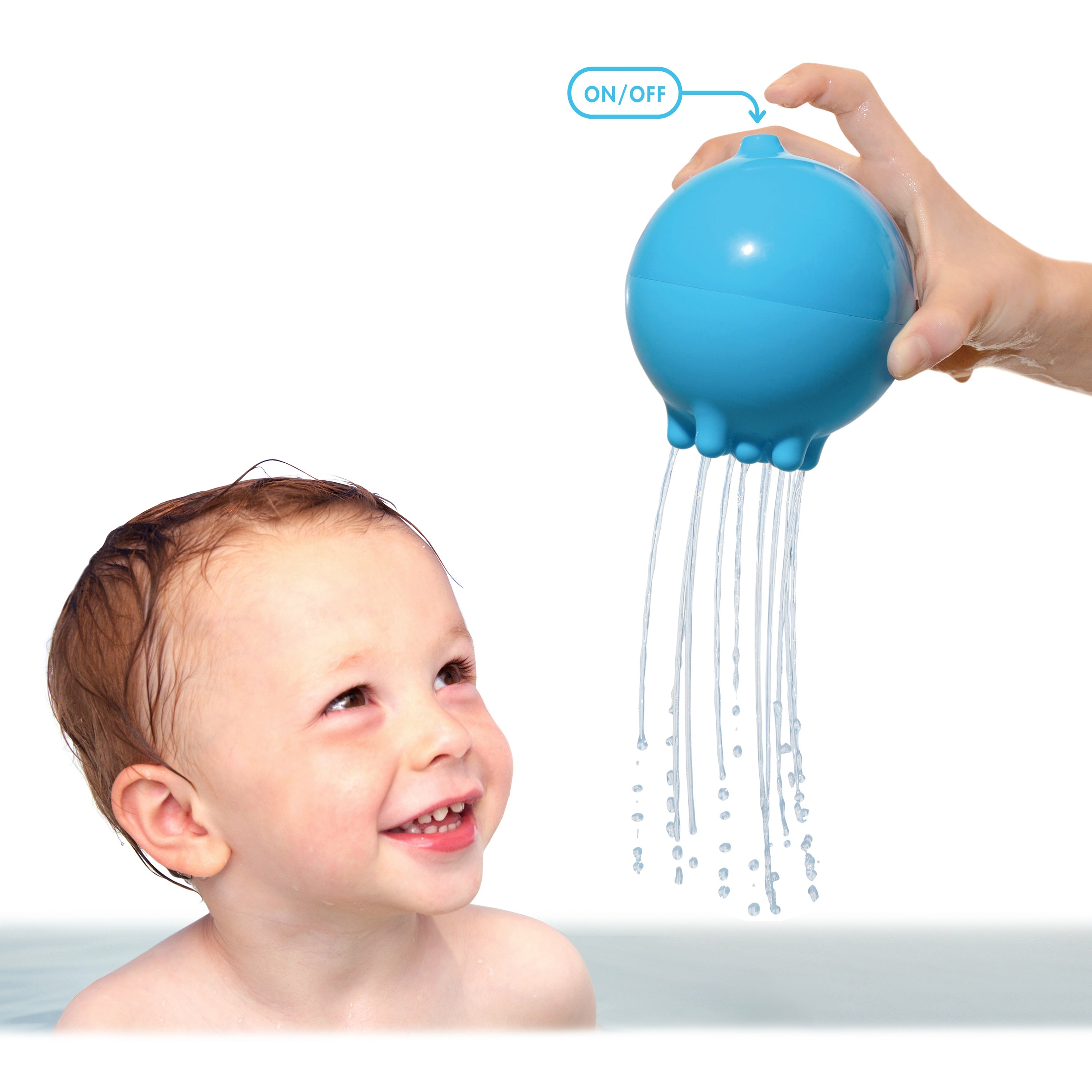 Smiling toddler in the bath watching an adult pour water from a blue Pluï Rainball by MOLUK, demonstrating the on/off air hole that controls the flow of water.