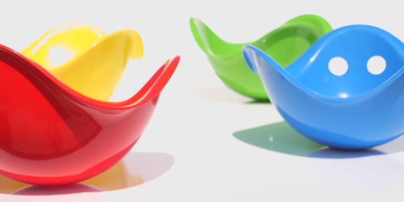 Colorful Bilibo play shells by MOLUK, spinning and rocking.