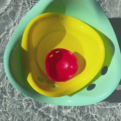 Children playing with Bilibo Midi indoors and outdoors – rocking, stacking, water play, and movement exploration.
