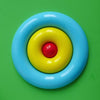 Nello color puzzle and skill toy by MOLUK shown in action with the centre piece rolling around  the outer ring.