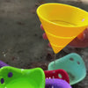 Water Science video of MOLUK’s Hix silicone cones used as sensory toys in water play—pouring like funnels and shooting off like rockets on a fountain.